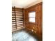 Bonus room features wood paneled walls, built in shelving, and stone tile flooring at 182 Tree Cutters, Sanford, NC 27332