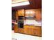 Kitchen with updated appliances and warm wood cabinetry at 182 Tree Cutters, Sanford, NC 27332