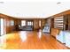 A spacious living room has hardwood flooring, wood paneling, and a seating area at 182 Tree Cutters, Sanford, NC 27332