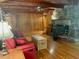 Cozy living room features a stone fireplace, wood paneling, and hardwood floors at 182 Tree Cutters, Sanford, NC 27332