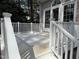 View of a painted deck with white railings and access to the house through French doors at 1904 Baronsmede Dr, Raleigh, NC 27615