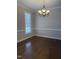 Spacious dining room boasting hardwood floors, elegant chandelier, and classic molding at 1904 Baronsmede Dr, Raleigh, NC 27615