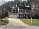 Charming two-story home featuring a two-car garage, dormer windows and a manicured lawn at 1904 Baronsmede Dr, Raleigh, NC 27615