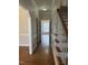 Hallway features hardwood flooring, white trim, and leads to a room filled with natural light at 1904 Baronsmede Dr, Raleigh, NC 27615