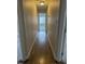 Hallway featuring gleaming hardwood floors and neutral colored walls at 1904 Baronsmede Dr, Raleigh, NC 27615