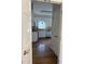 View through doorway to kitchen featuring white cabinets, appliances, and trim at 1904 Baronsmede Dr, Raleigh, NC 27615