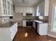 Bright kitchen featuring white cabinetry, stainless steel appliances, granite countertops and tile backsplash at 1904 Baronsmede Dr, Raleigh, NC 27615