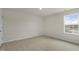 Bright bedroom with neutral walls and carpet, with a sunny window at 209 Leven Dr, Gibsonville, NC 27249