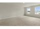 Large bedroom with two bright windows and neutral carpet at 209 Leven Dr, Gibsonville, NC 27249