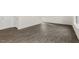 Spacious living area showcasing modern gray wood-look flooring and natural light at 209 Leven Dr, Gibsonville, NC 27249