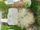 Overhead view of roof of house and backyard with mature trees, fire pit, and patio at 209 Plyersmill Rd, Cary, NC 27519