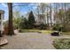 Expansive backyard features landscaping, sitting area, gravel, and mature trees at 209 Plyersmill Rd, Cary, NC 27519