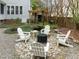 Cozy backyard setting with stone patio, Adirondack chairs, and a fire pit at 209 Plyersmill Rd, Cary, NC 27519