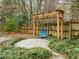 Backyard retreat features unique swing, stone patio, and lush landscaping at 209 Plyersmill Rd, Cary, NC 27519