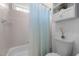 Bright bathroom featuring a tiled bathtub with shower and updated beadboard paneling at 209 Plyersmill Rd, Cary, NC 27519
