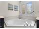 Close up of the soaking tub in the bathroom with a large window at 209 Plyersmill Rd, Cary, NC 27519