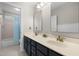 Bathroom with double sinks, vanity with navy blue cabinets, and a separate toilet and shower area at 209 Plyersmill Rd, Cary, NC 27519