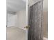 Hallway leading to a bathroom featuring a tub with a decorative shower curtain at 209 Plyersmill Rd, Cary, NC 27519