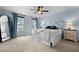 Light blue bedroom with a ceiling fan and a large mirror at 209 Plyersmill Rd, Cary, NC 27519