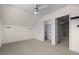 Bright bedroom features neutral carpet, ceiling fan, closet, and access to additional rooms at 209 Plyersmill Rd, Cary, NC 27519