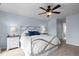 Cozy bedroom featuring carpeted floors, light blue walls, and a ceiling fan with a light fixture at 209 Plyersmill Rd, Cary, NC 27519