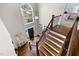 Bright foyer featuring hardwood floors, a grand staircase, and a large window showcasing the exterior at 209 Plyersmill Rd, Cary, NC 27519