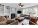 Living room with fireplace, built-in bookshelves, and plush seating at 209 Plyersmill Rd, Cary, NC 27519