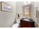Charming powder room with a decorative mirror, a classic vanity, and a framed artwork, creating a cozy ambiance at 209 Plyersmill Rd, Cary, NC 27519