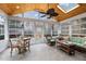 Relaxing sunroom with wood ceilings, skylight, many windows, tile flooring, and stylish furnishings at 209 Plyersmill Rd, Cary, NC 27519