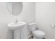 Bathroom featuring a pedestal sink and toilet, all in white at 215 Leven Dr, Gibsonville, NC 27249
