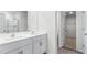 Modern bathroom featuring double sinks, stylish cabinets, and wood-look flooring at 215 Leven Dr, Gibsonville, NC 27249