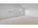 Bright bedroom with two windows and neutral carpeting at 215 Leven Dr, Gibsonville, NC 27249