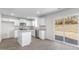 Modern kitchen with white cabinetry, granite countertops, and stainless steel appliances, leading to a patio at 215 Leven Dr, Gibsonville, NC 27249
