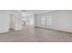 Open living room showcasing wood floors, white walls, and a glimpse into the modern kitchen at 215 Leven Dr, Gibsonville, NC 27249