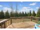 View of the wooden deck overlooking the lawn surrounded by trees at 224 Swann Trl, Clayton, NC 27527