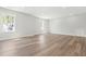 Unfinished basement space with wood floors and windows for natural light, ready for customization at 230 Sutherland Dr, Franklinton, NC 27525
