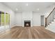 Finished basement with fireplace, sliding glass door, wood-look flooring, and staircase at 230 Sutherland Dr, Franklinton, NC 27525
