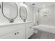 Modern bathroom with double vanity, black fixtures, tiled shower/tub and patterned flooring at 230 Sutherland Dr, Franklinton, NC 27525