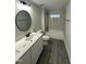 Modern bathroom with a single sink vanity, tiled floors, and a tiled shower-tub combination at 230 Sutherland Dr, Franklinton, NC 27525