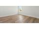 Bright bedroom with wood-look flooring features a window with natural light at 230 Sutherland Dr, Franklinton, NC 27525