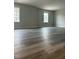 Spacious room featuring two windows and stylish wood flooring for a modern aesthetic at 230 Sutherland Dr, Franklinton, NC 27525