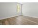 Well-lit bedroom features wood-look flooring and a bright, sunny window at 230 Sutherland Dr, Franklinton, NC 27525