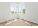 Bright bedroom featuring a corner window with neighborhood views and light wood-look flooring at 230 Sutherland Dr, Franklinton, NC 27525