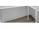 Walk-in closet with white shelving, rod, and wood floor at 230 Sutherland Dr, Franklinton, NC 27525