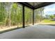 Outdoor patio space offering shade and a view of the natural wooded area behind the property at 230 Sutherland Dr, Franklinton, NC 27525