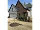 Charming home featuring a blend of brick and siding, black trim, manicured lawn, and a tree in the front yard at 230 Sutherland Dr, Franklinton, NC 27525