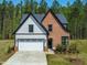 Charming home with a two-car garage, brick and siding, and well-manicured lawn at 230 Sutherland Dr, Franklinton, NC 27525