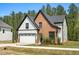 Elegant home featuring brick and siding, a two-car garage, and landscaped front yard at 230 Sutherland Dr, Franklinton, NC 27525