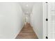 A bright hallway with wood floors and white walls, leading to various rooms at 230 Sutherland Dr, Franklinton, NC 27525