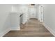 Hallway has wood-look flooring and access to bedrooms and bathrooms at 230 Sutherland Dr, Franklinton, NC 27525